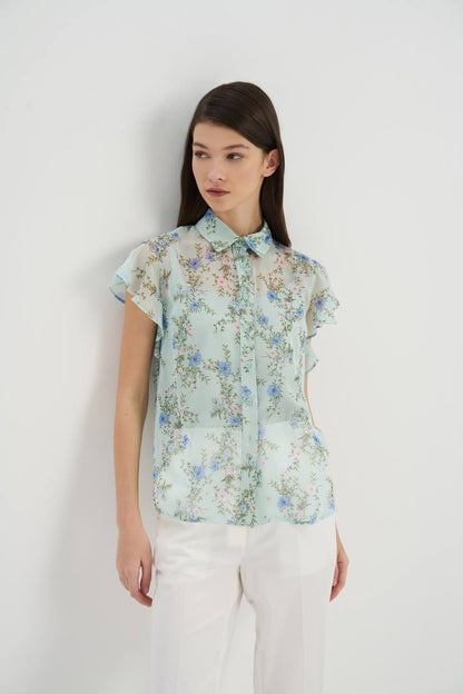 This is a breezy and feminine blouse designed with lightweight chiffon fabric. The blouse has a relaxed fit that drapes elegantly, and features delicate pleats that add texture and movement to the garment. The flowy design creates a graceful and ethereal silhouette, making it a perfect choice for a chic and effortless look.